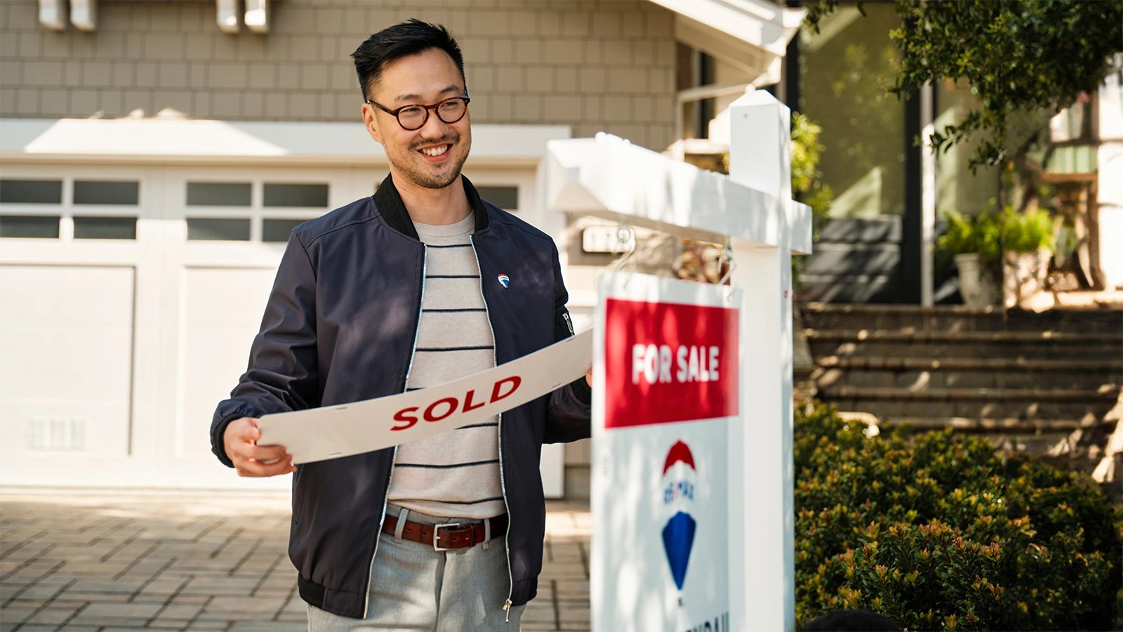 Man with sold sign